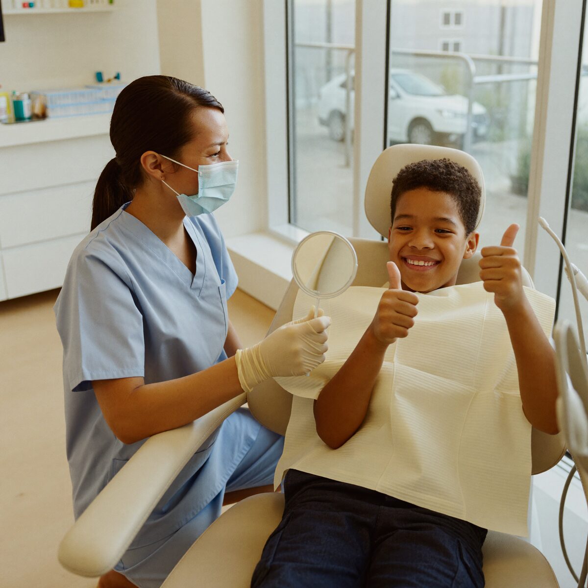 A friendly dentist reassuring a young child during a check-up at High Oaks Dental Practice, St Albans