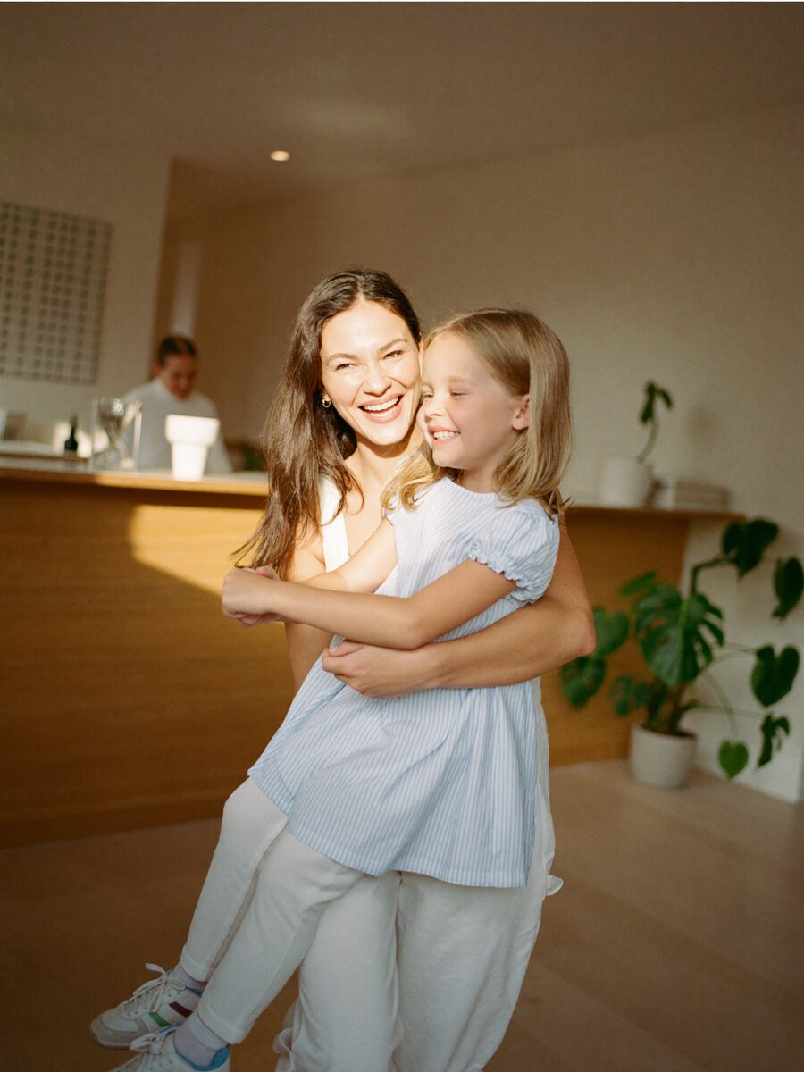 A smiling mother and her young daughter after a dental visit